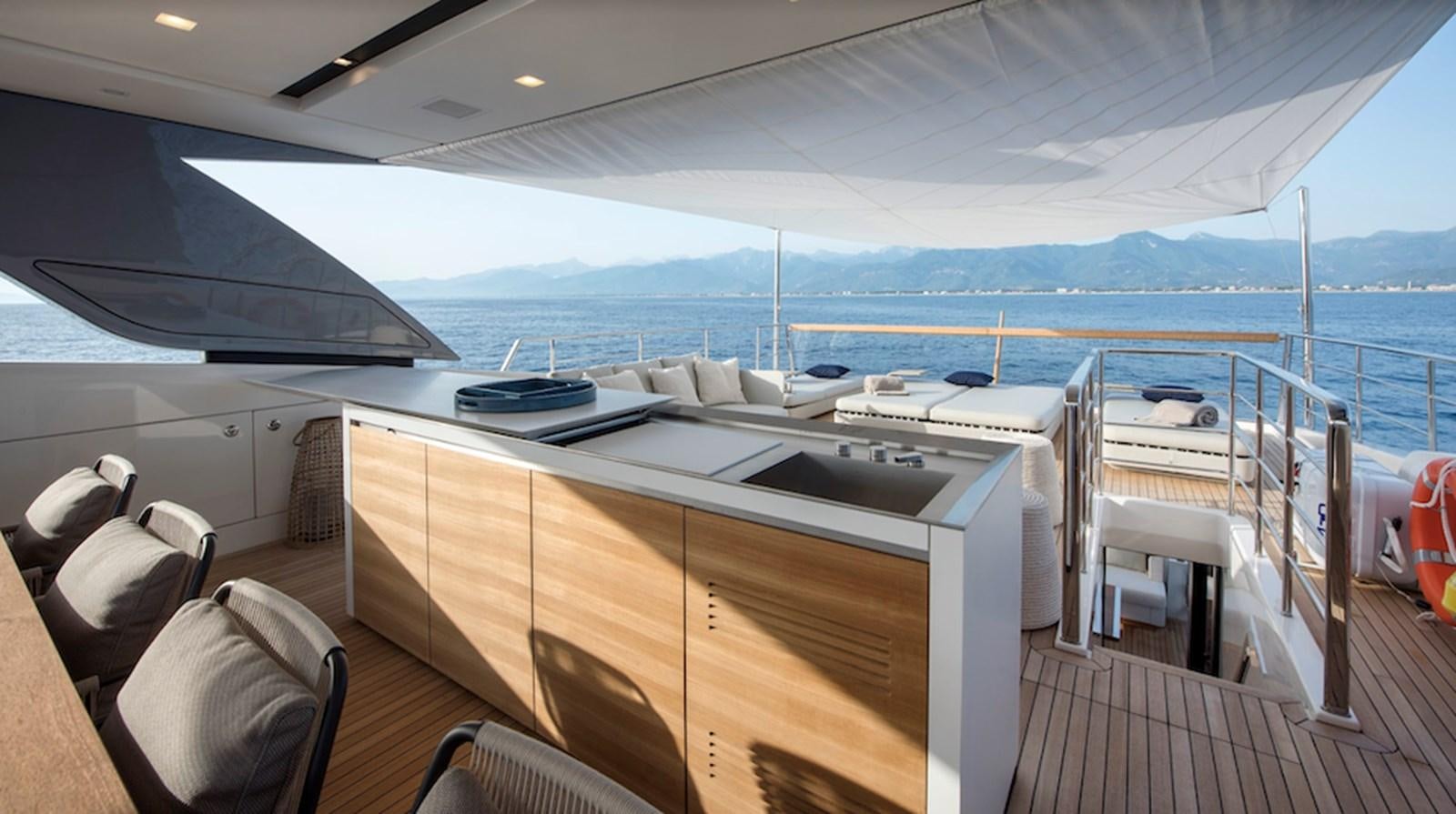a deck with a large deck overlooking the ocean aboard DINAIA Yacht for Charter