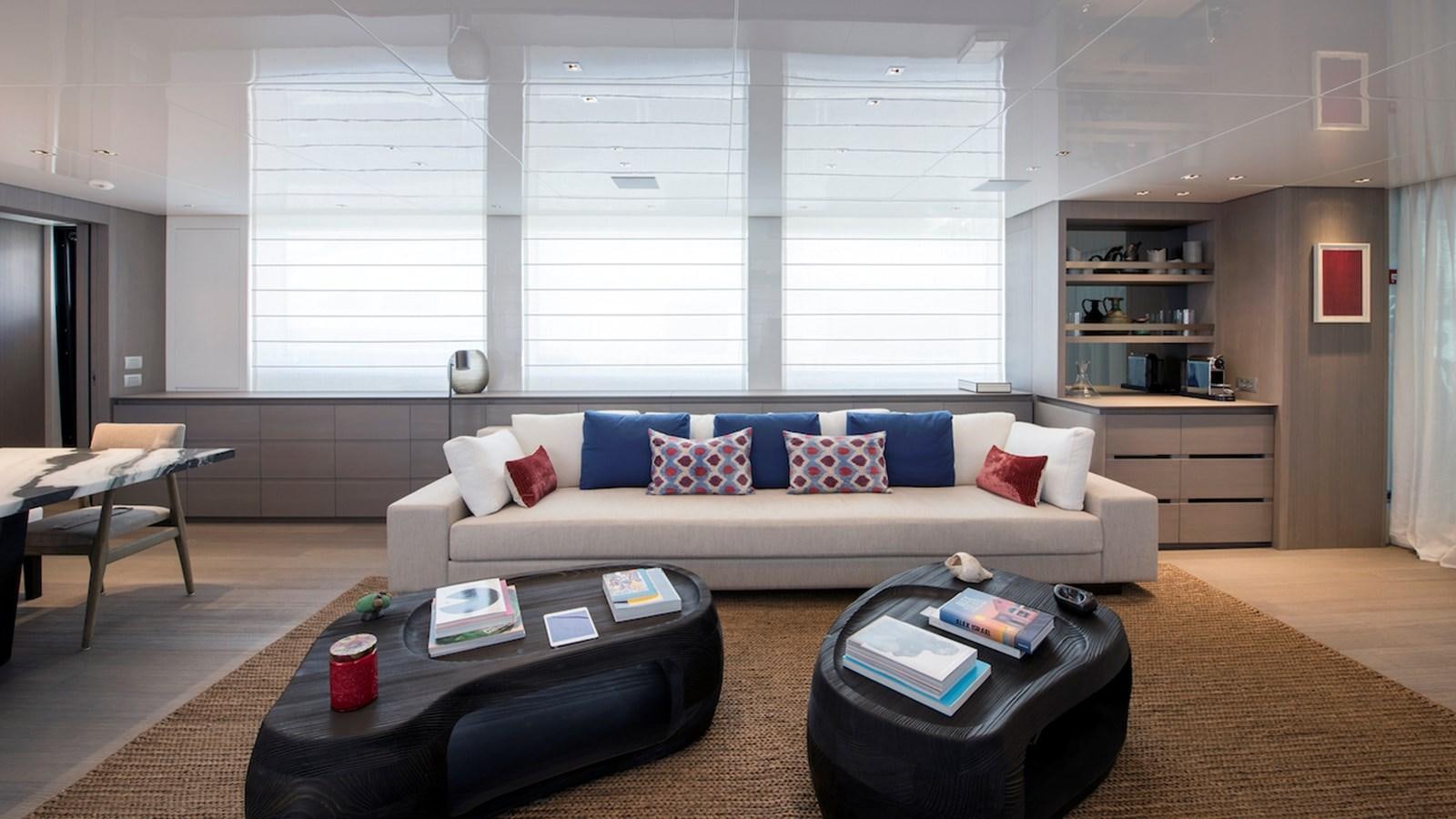 a living room with a couch and a table aboard SANLORENZO SL106 Yacht for Sale