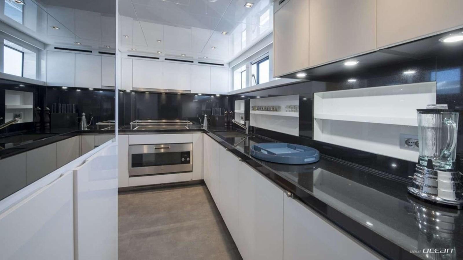 a kitchen with white cabinets aboard SANLORENZO SL106 Yacht for Sale