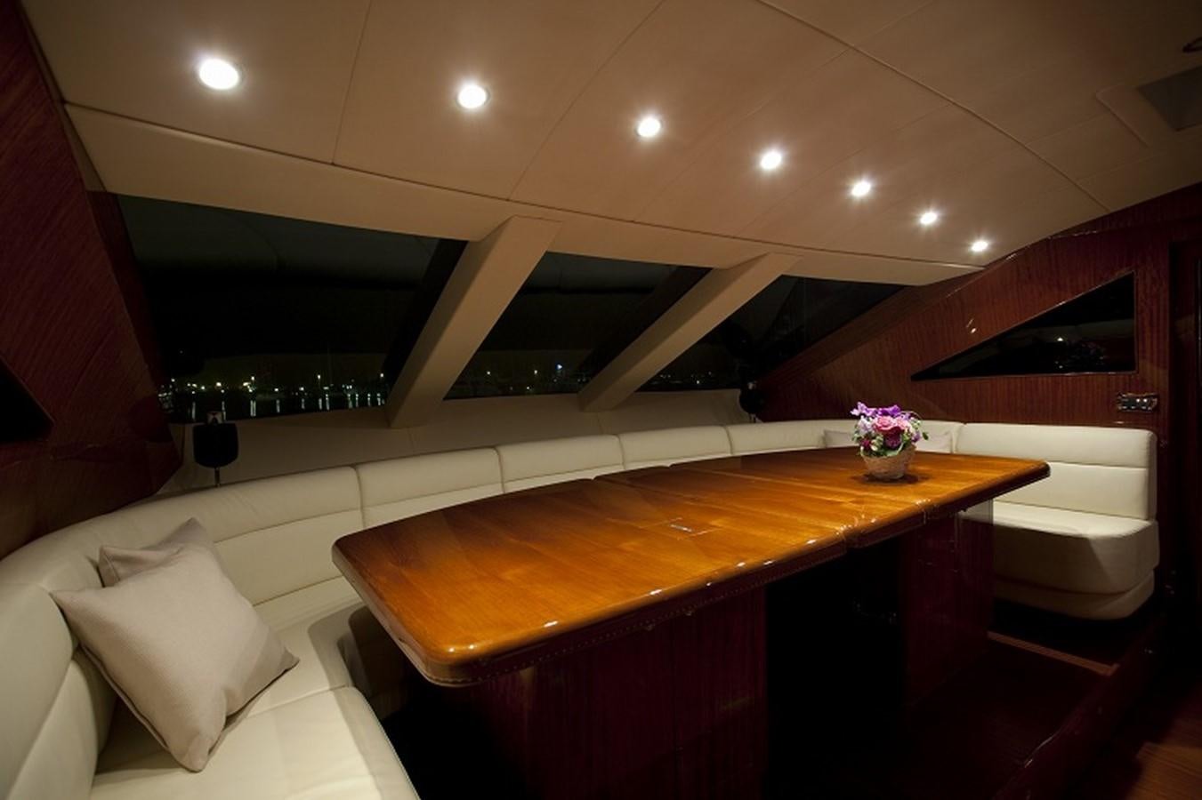 a room with a table and chairs aboard QUEEN GRACE Yacht for Sale