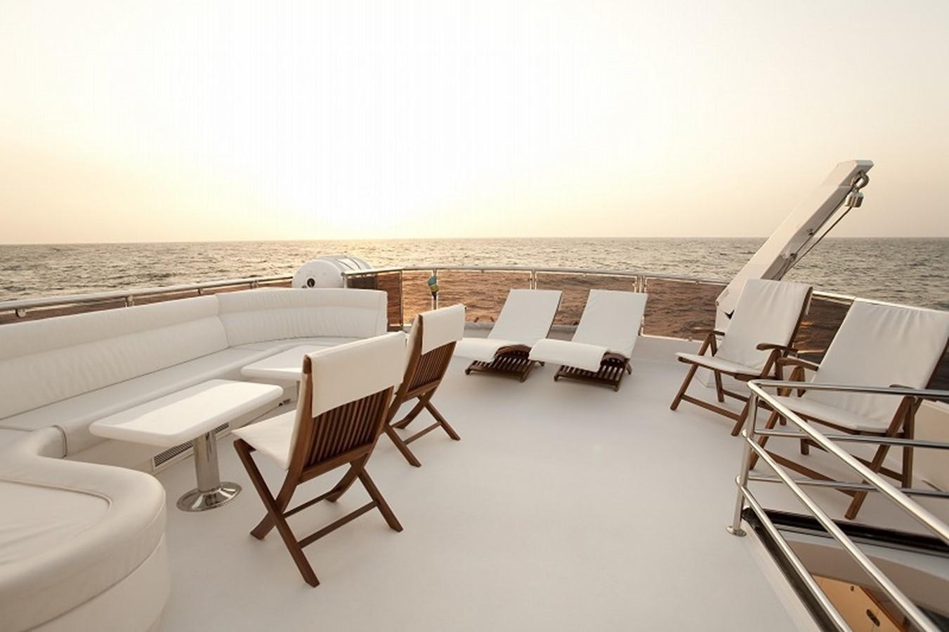 a deck with chairs and tables on it aboard QUEEN GRACE Yacht for Sale
