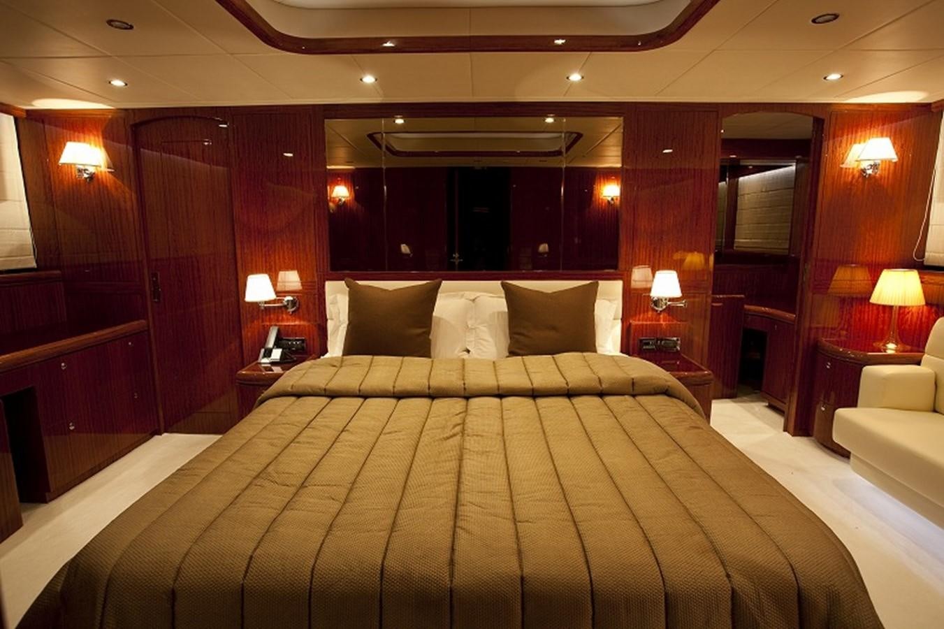 a large bed with a white comforter and pillows aboard QUEEN GRACE Yacht for Sale