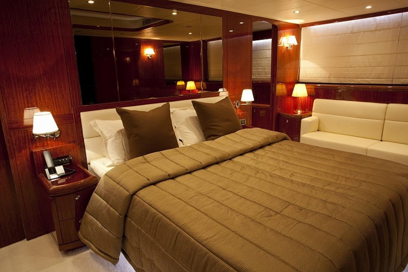 a hotel room with a bed and a couch aboard QUEEN GRACE Yacht for Sale