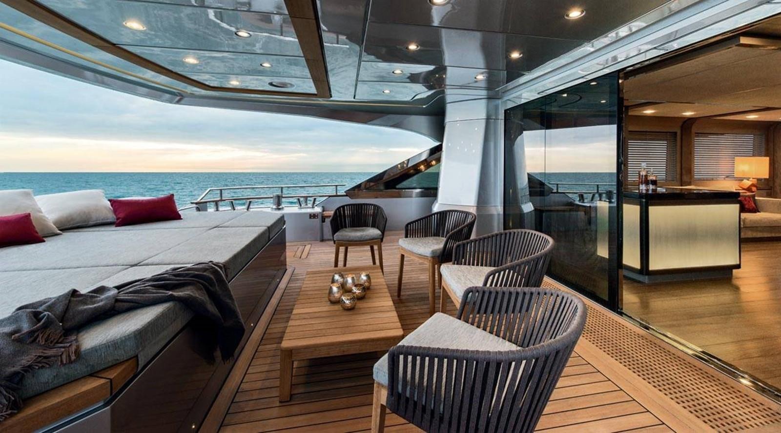 a room with a bed and a table and chairs aboard MONTE CARLO YACHTS MCY 105 Yacht for Sale