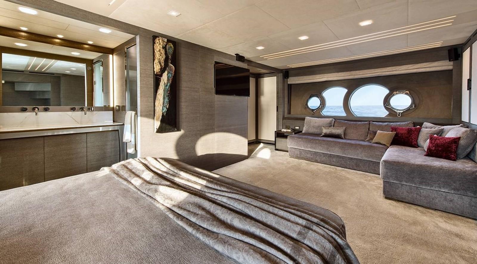 a large room with a bed and a couch aboard MONTE CARLO YACHTS MCY 105 Yacht for Sale