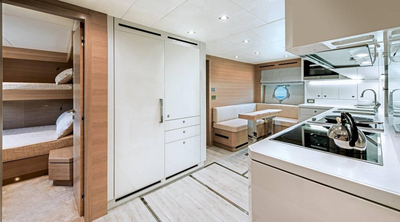 a small kitchen with a bed and a sink aboard MONTE CARLO YACHTS MCY 105 Yacht for Sale