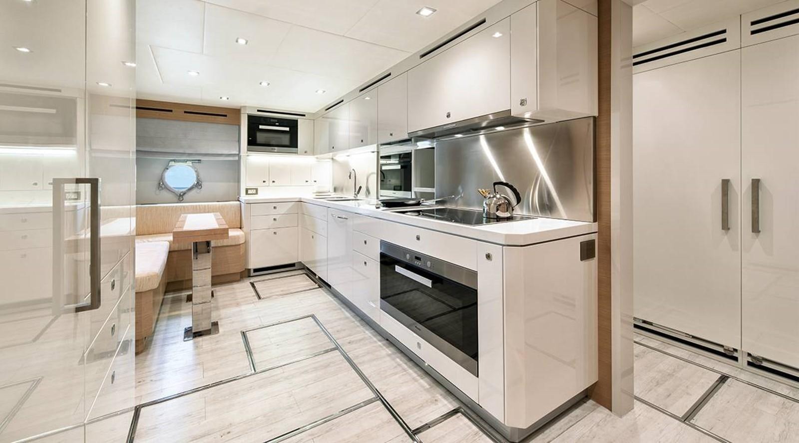 a kitchen with white cabinets aboard MONTE CARLO YACHTS MCY 105 Yacht for Sale