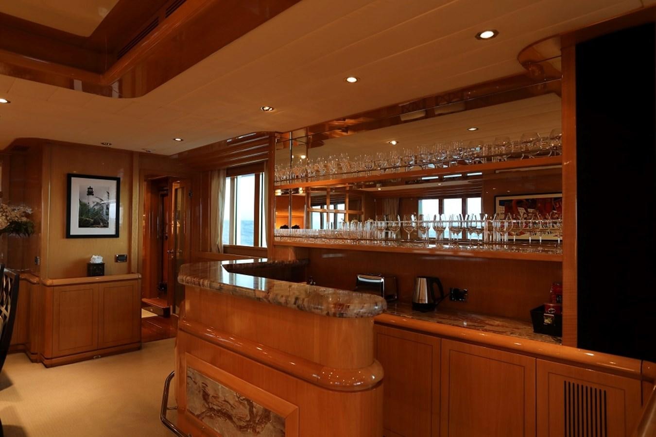 a bar with a bar and a table aboard INDIGO Yacht for Sale