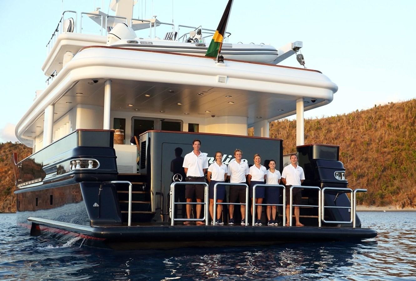 a group of people standing on a boat aboard INDIGO Yacht for Sale