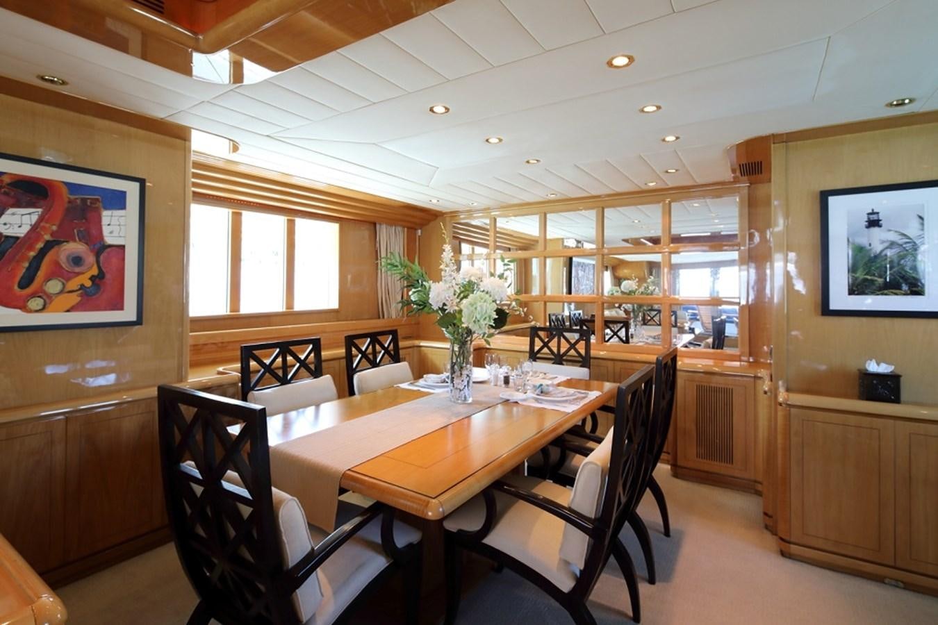 a dining room with a table and chairs aboard INDIGO Yacht for Sale