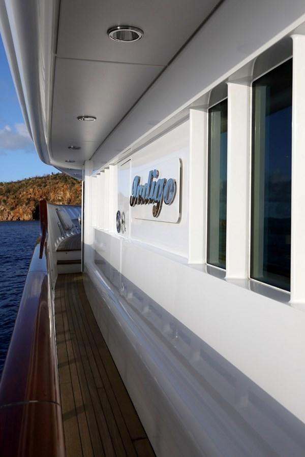 a white house with a deck and a blue railing aboard INDIGO Yacht for Sale