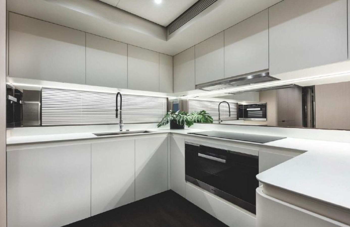 a kitchen with white cabinets aboard ALBA Yacht for Sale