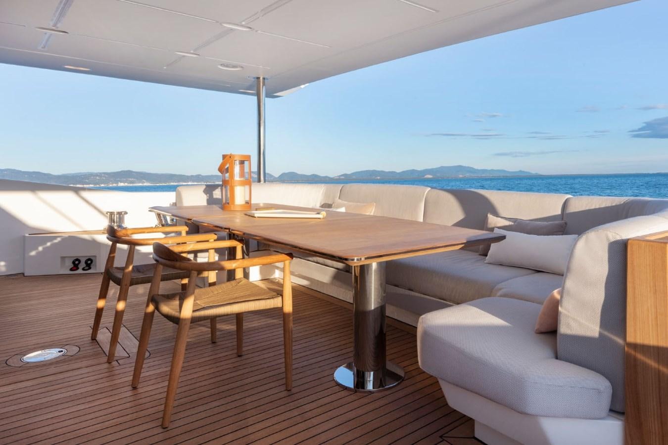 a table and chairs on a deck aboard ALBA Yacht for Sale