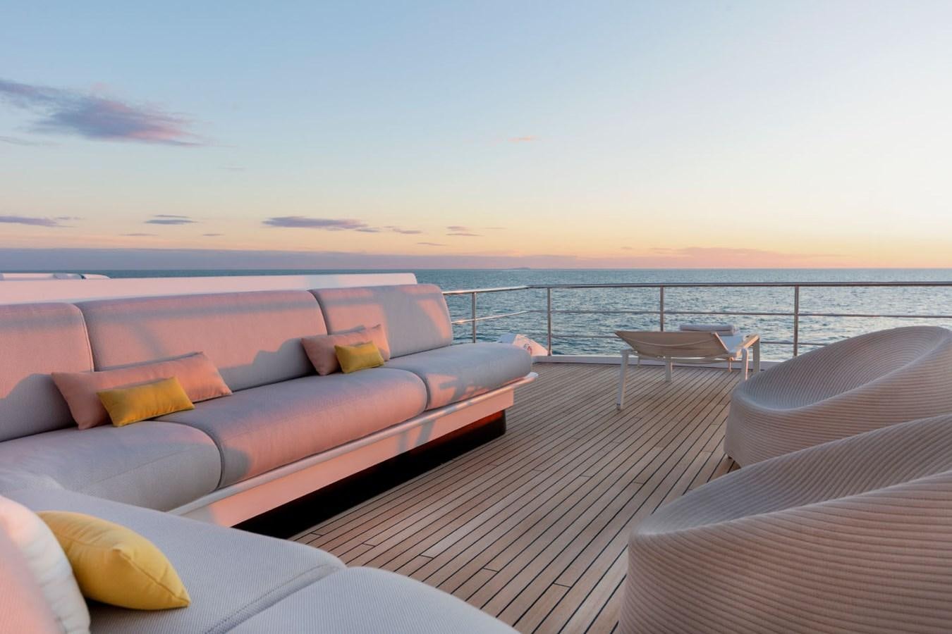 a large bed on a deck overlooking a large body of water aboard ALBA Yacht for Sale