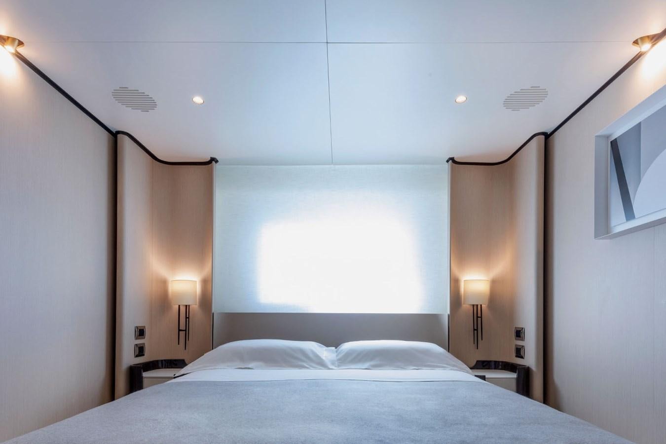 a bed with a blue sheet aboard ALBA Yacht for Sale