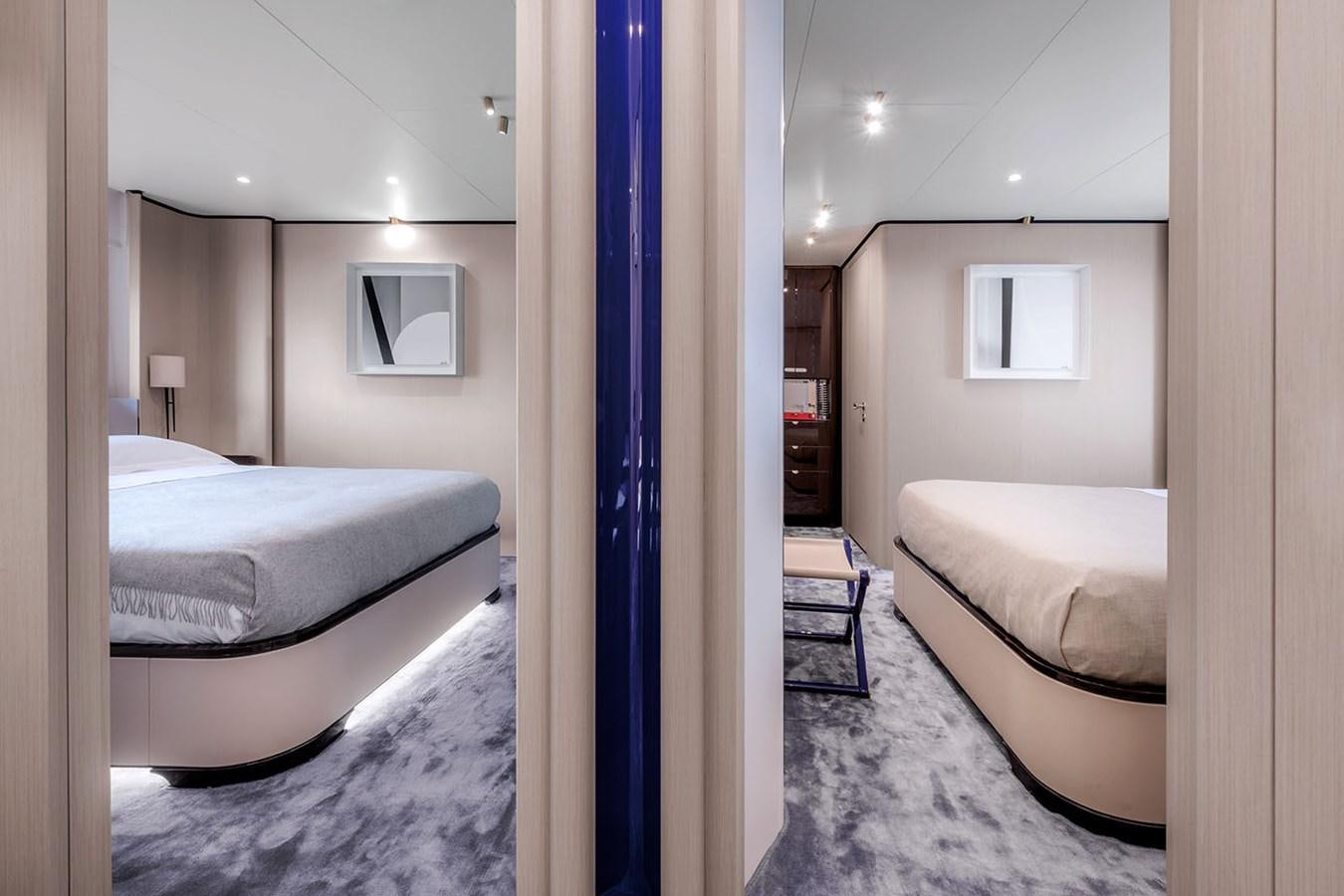 a room with a couple of beds aboard ALBA Yacht for Sale