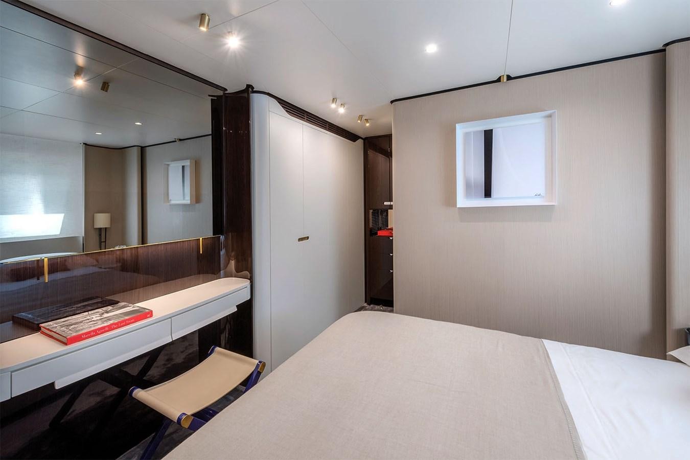 a room with a bed and a desk aboard ALBA Yacht for Sale