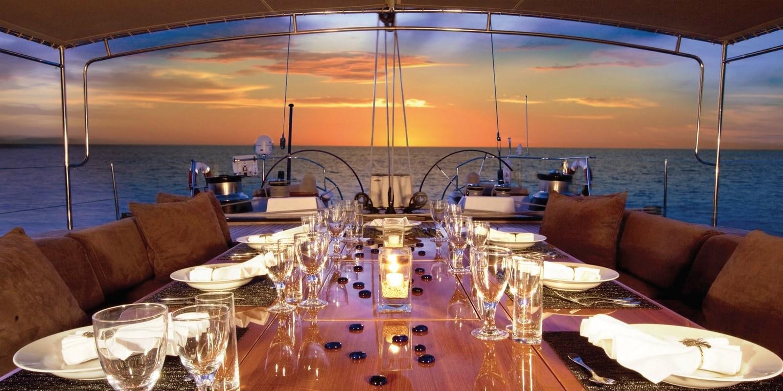 a table with plates and glasses on it aboard ASAHI Yacht for Sale