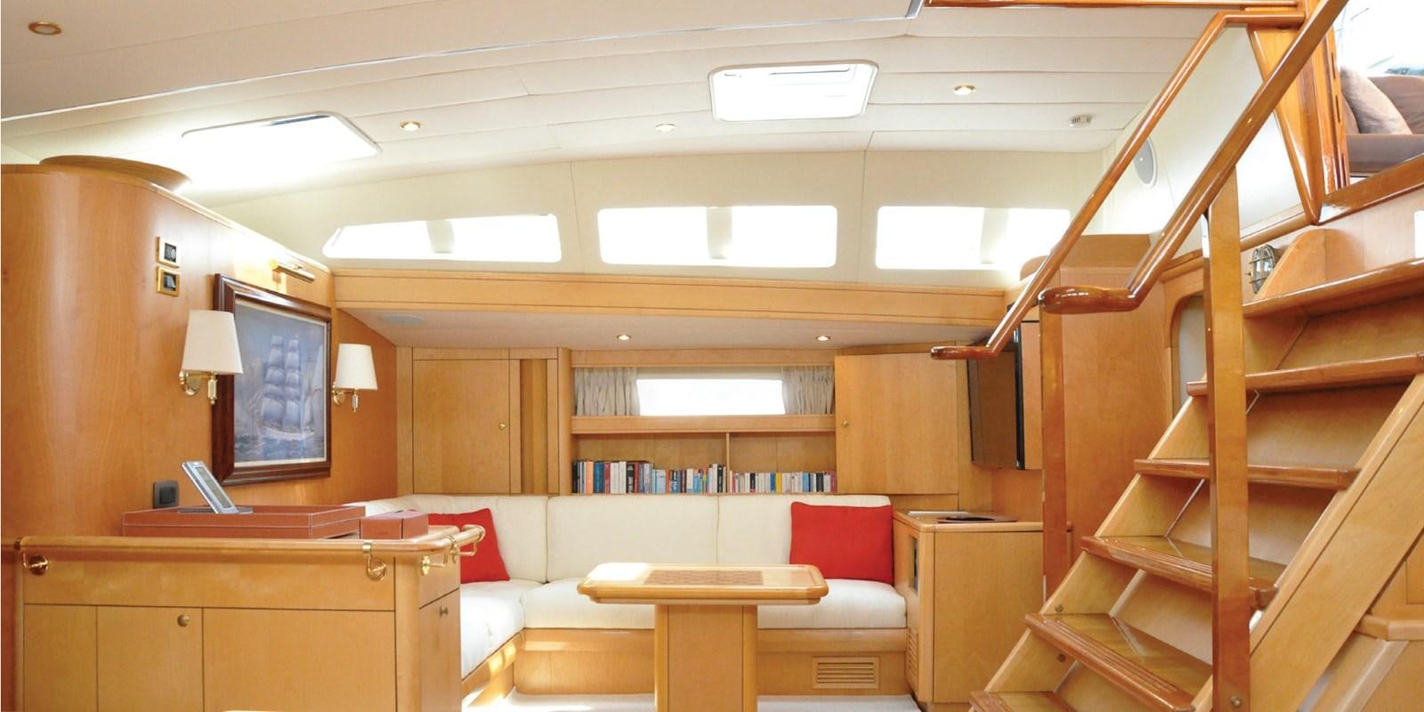 a room with a couch and a table and a bookcase aboard ASAHI Yacht for Sale