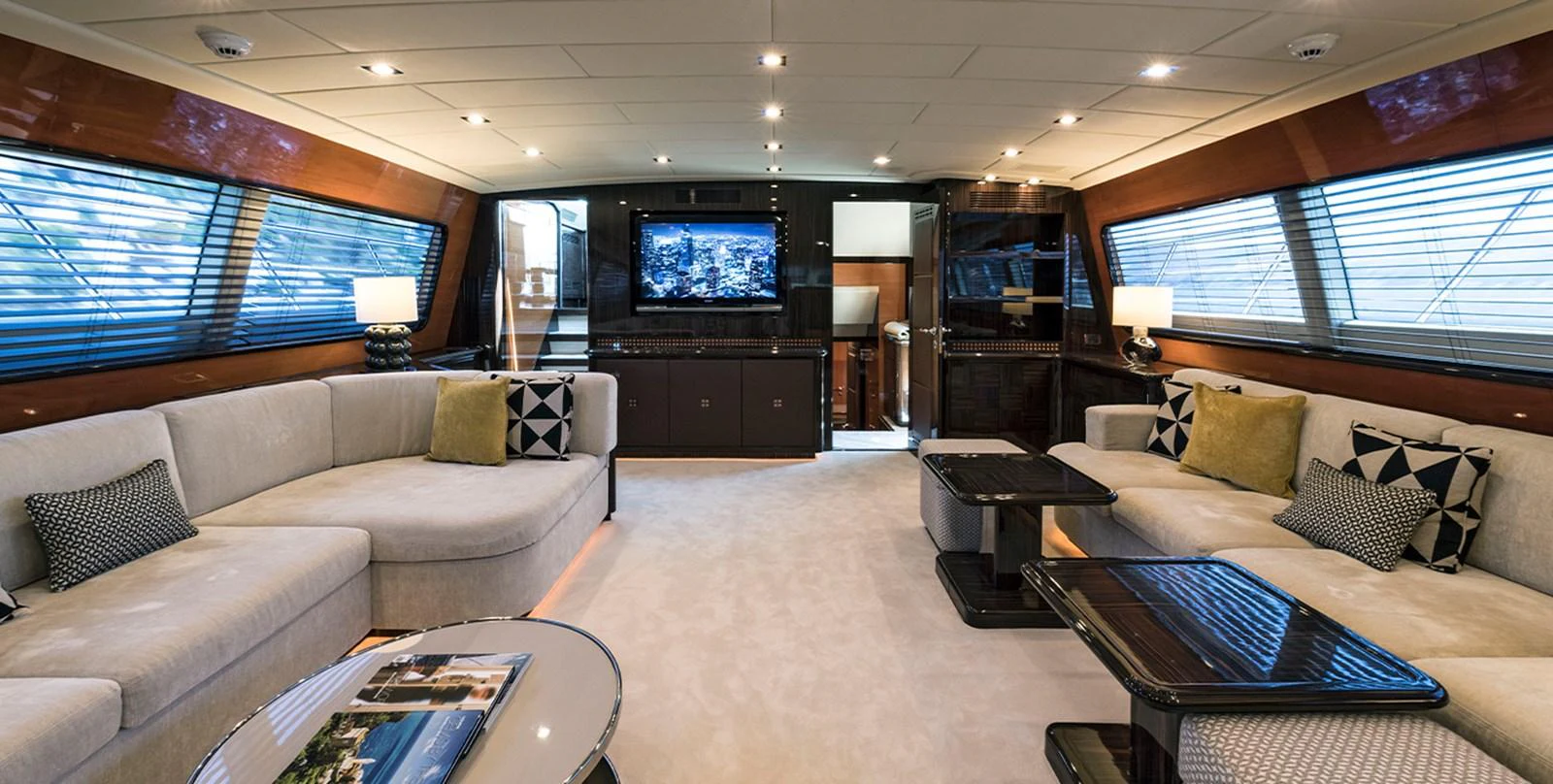 a living room with a large screen aboard DANUSH Yacht for Sale