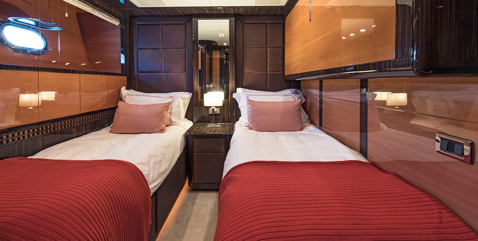 a room with beds and a mirror aboard DANUSH Yacht for Sale