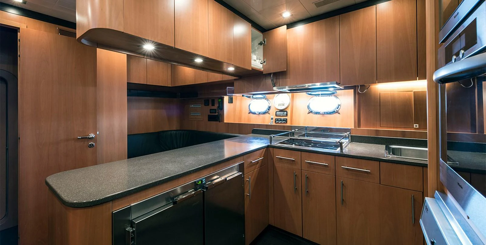 a kitchen with wooden cabinets aboard DANUSH Yacht for Sale
