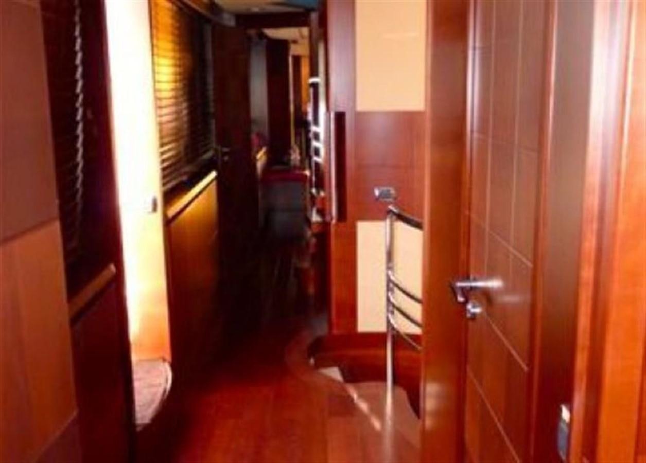 a hallway with a door and a railing aboard VIVERE Yacht for Sale