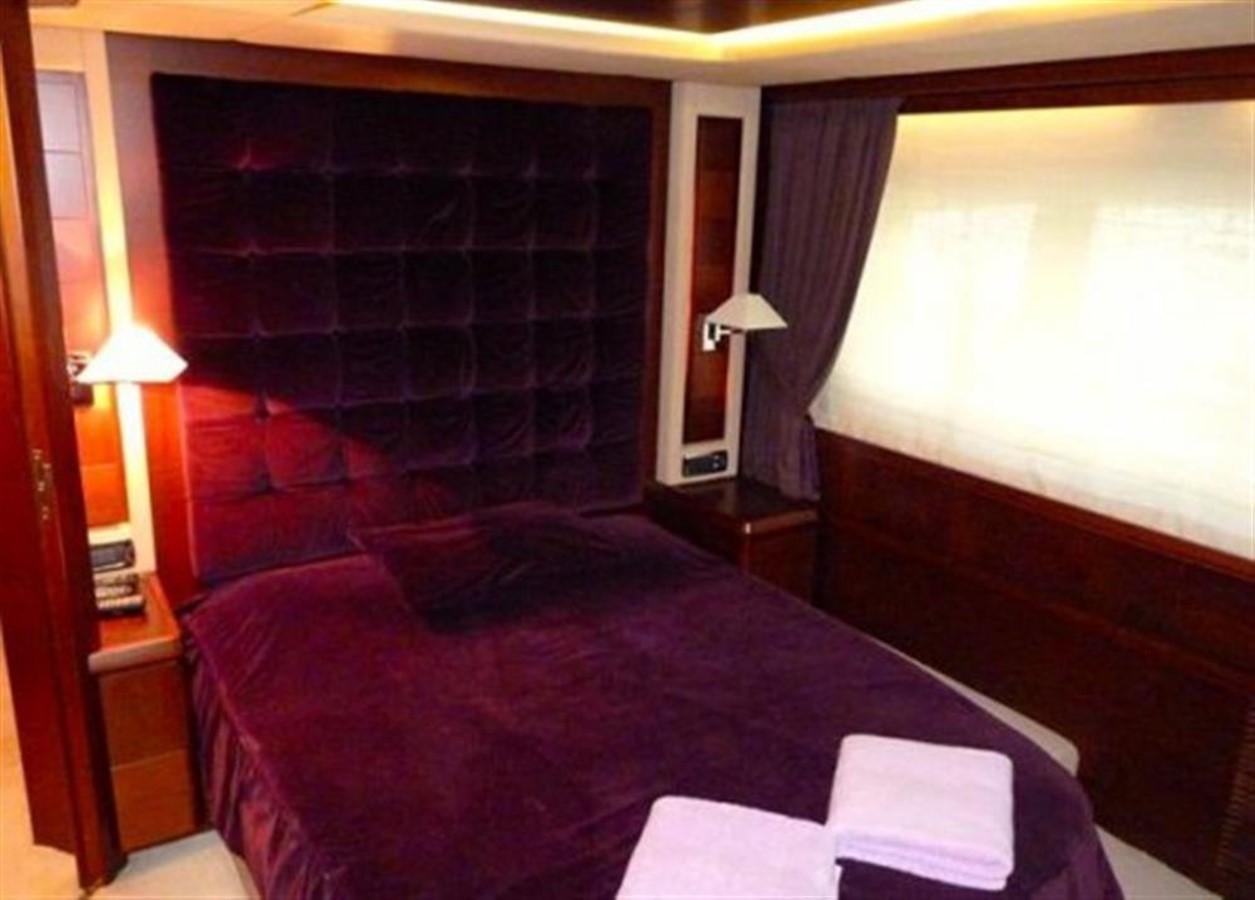 a bed with a black comforter aboard VIVERE Yacht for Sale