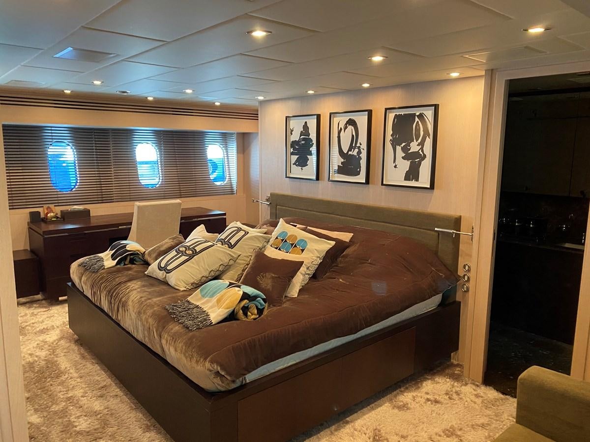 a bedroom with a bed and a couch aboard JADE Yacht for Sale