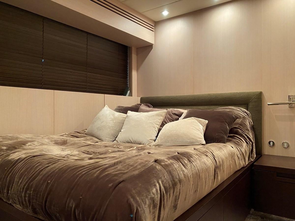 a bed with a brown comforter aboard JADE Yacht for Sale