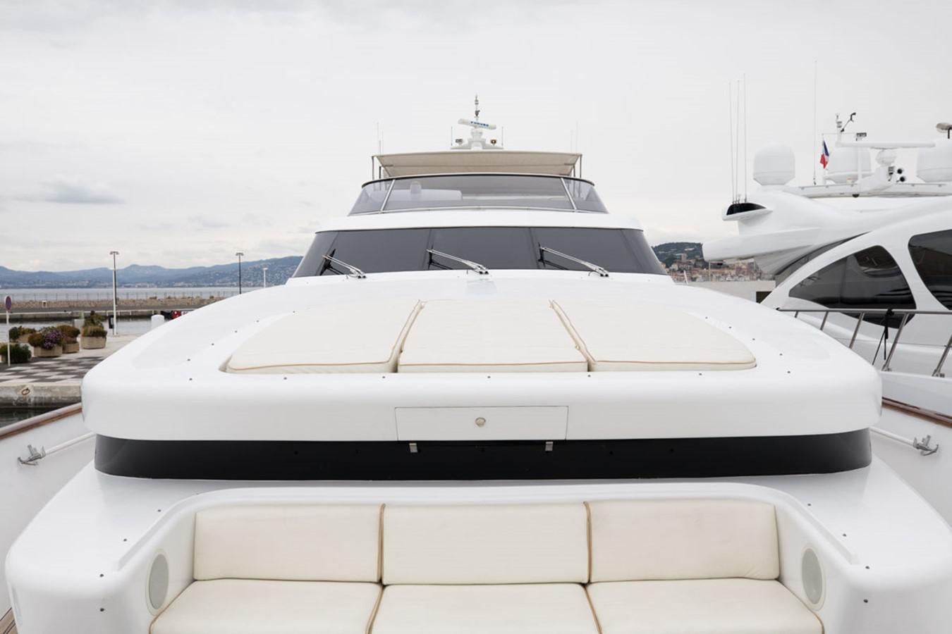 a white yacht on a dock aboard PARAM JAMUNA III Yacht for Sale