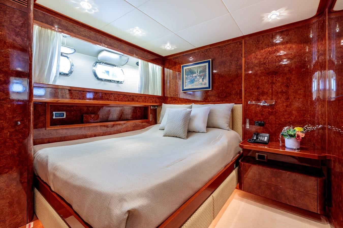 a room with a bed and a mirror aboard PARAM JAMUNA III Yacht for Sale