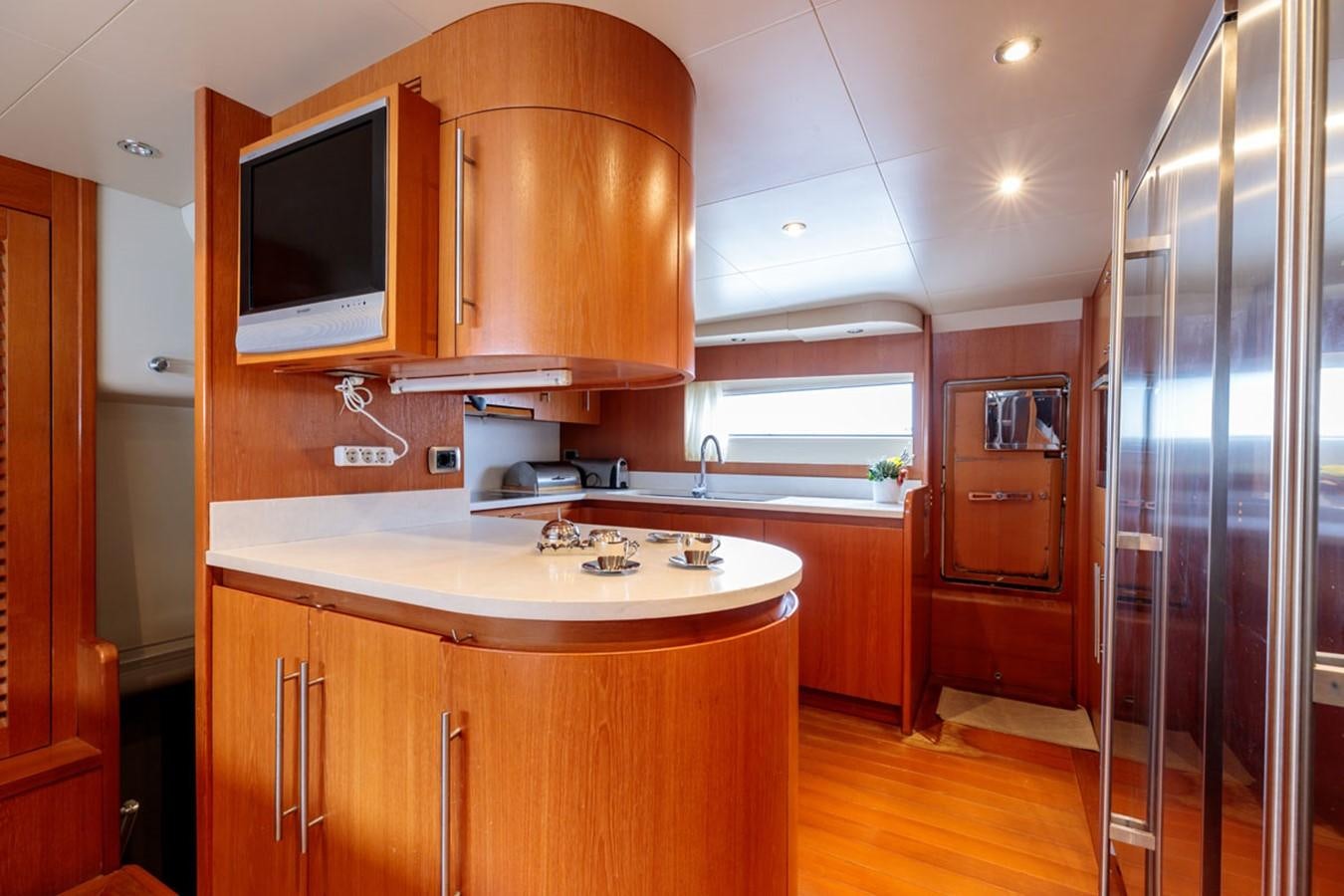 a kitchen with a glass door aboard PARAM JAMUNA III Yacht for Sale