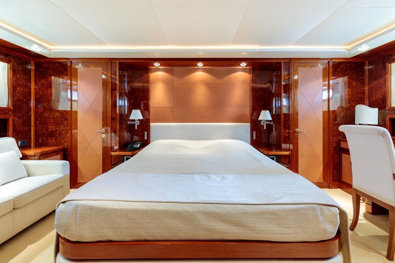 a room with a bed and a couch aboard PARAM JAMUNA III Yacht for Sale