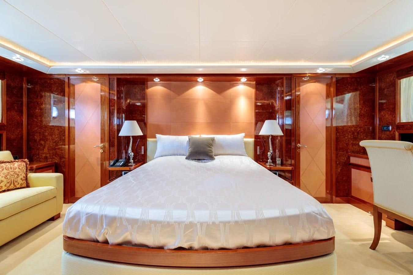 a bed with a white bed spread aboard PARAM JAMUNA III Yacht for Sale