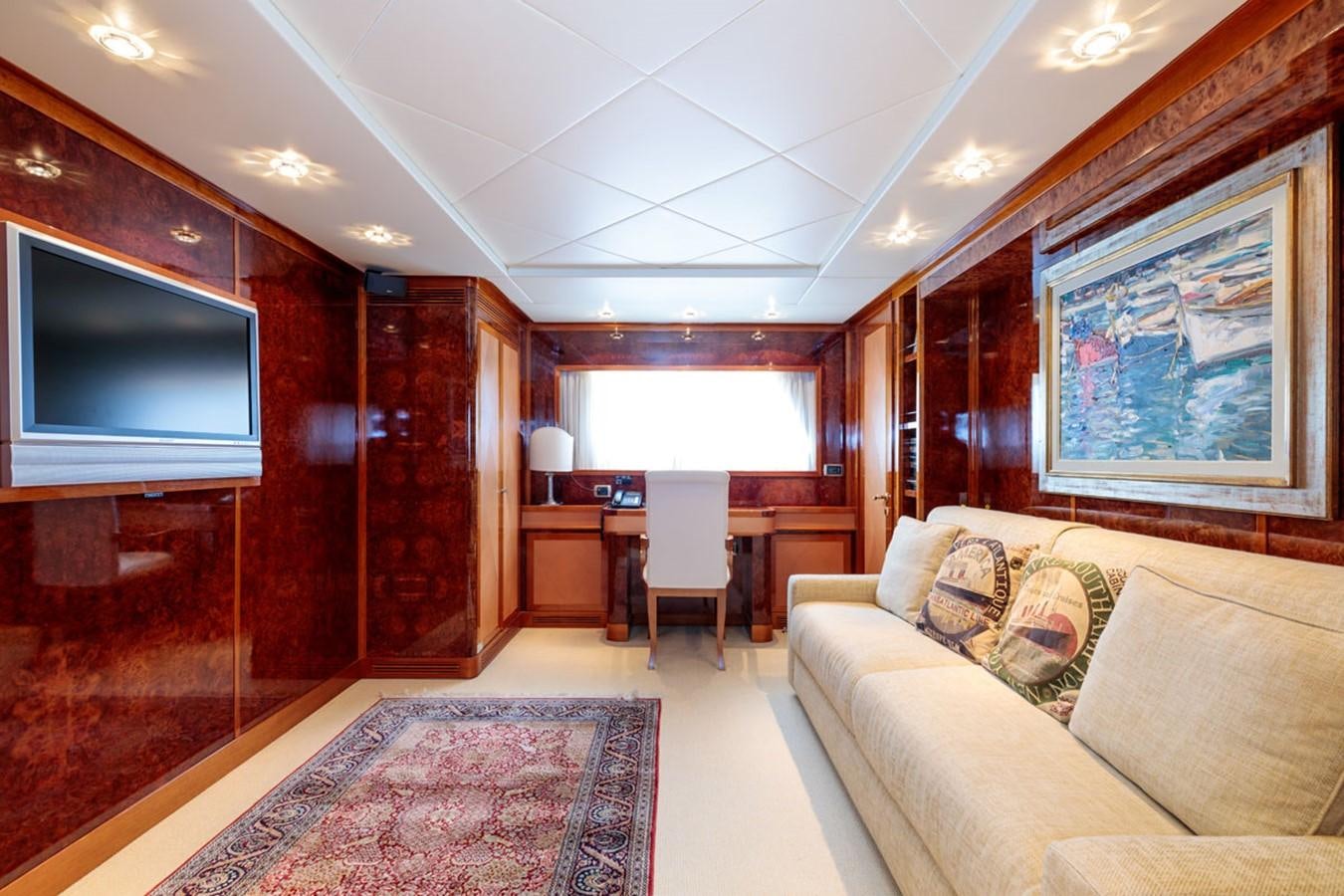 a living room with a couch and a tv aboard PARAM JAMUNA III Yacht for Sale