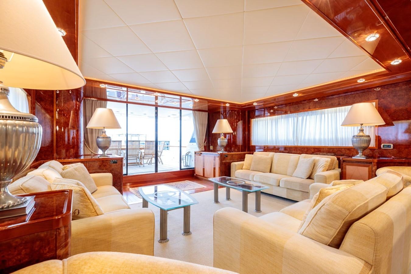a living room with a large window aboard PARAM JAMUNA III Yacht for Sale