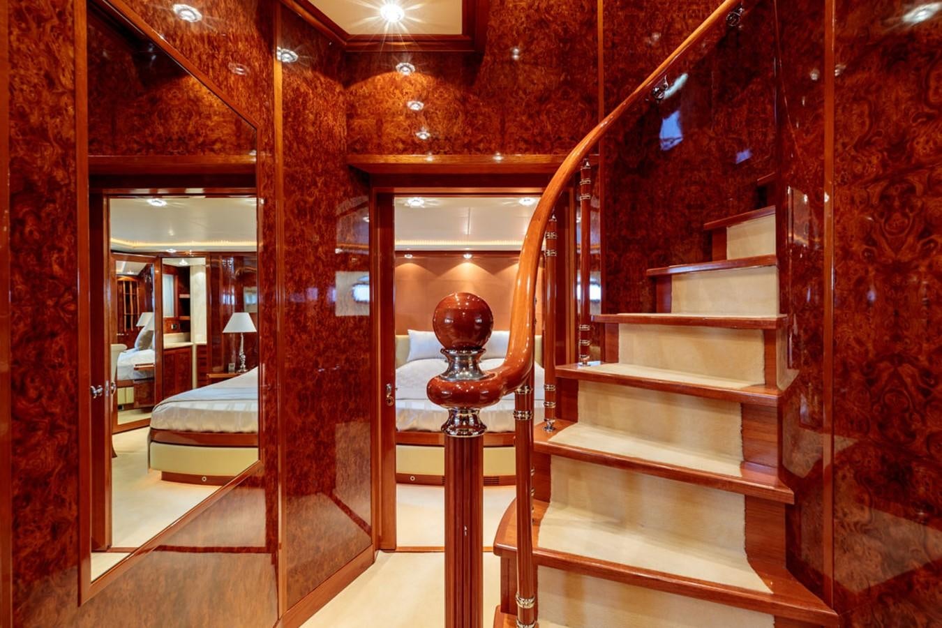 a room with a bed and a red wall aboard PARAM JAMUNA III Yacht for Sale