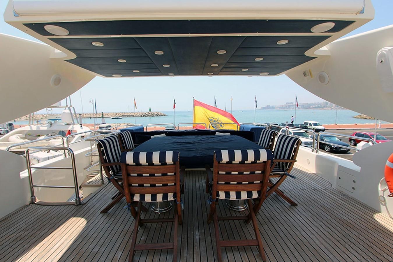 a table and chairs on a deck aboard MARIA JOSE Yacht for Sale