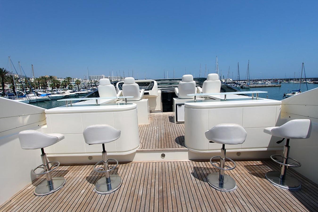 a deck with white chairs and tables aboard MARIA JOSE Yacht for Sale