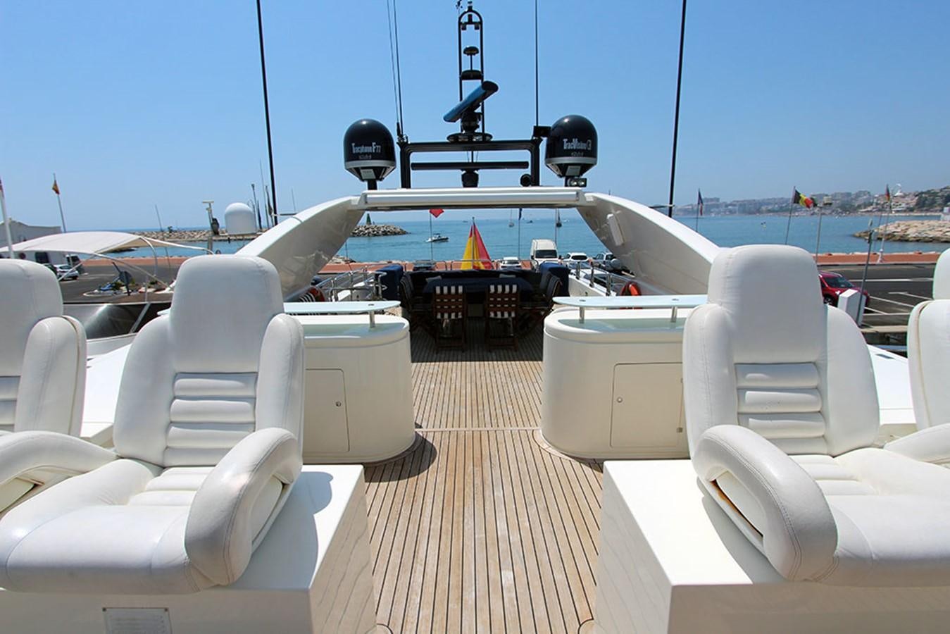 a deck with a deck and a view of the water and boats aboard MARIA JOSE Yacht for Sale