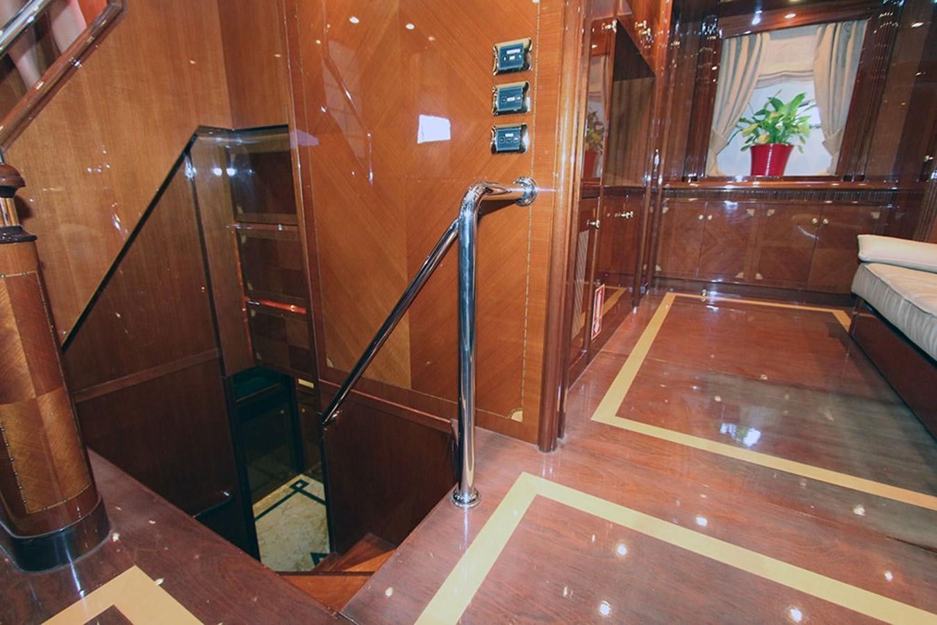 a room with wood floors and a ladder aboard MARIA JOSE Yacht for Sale