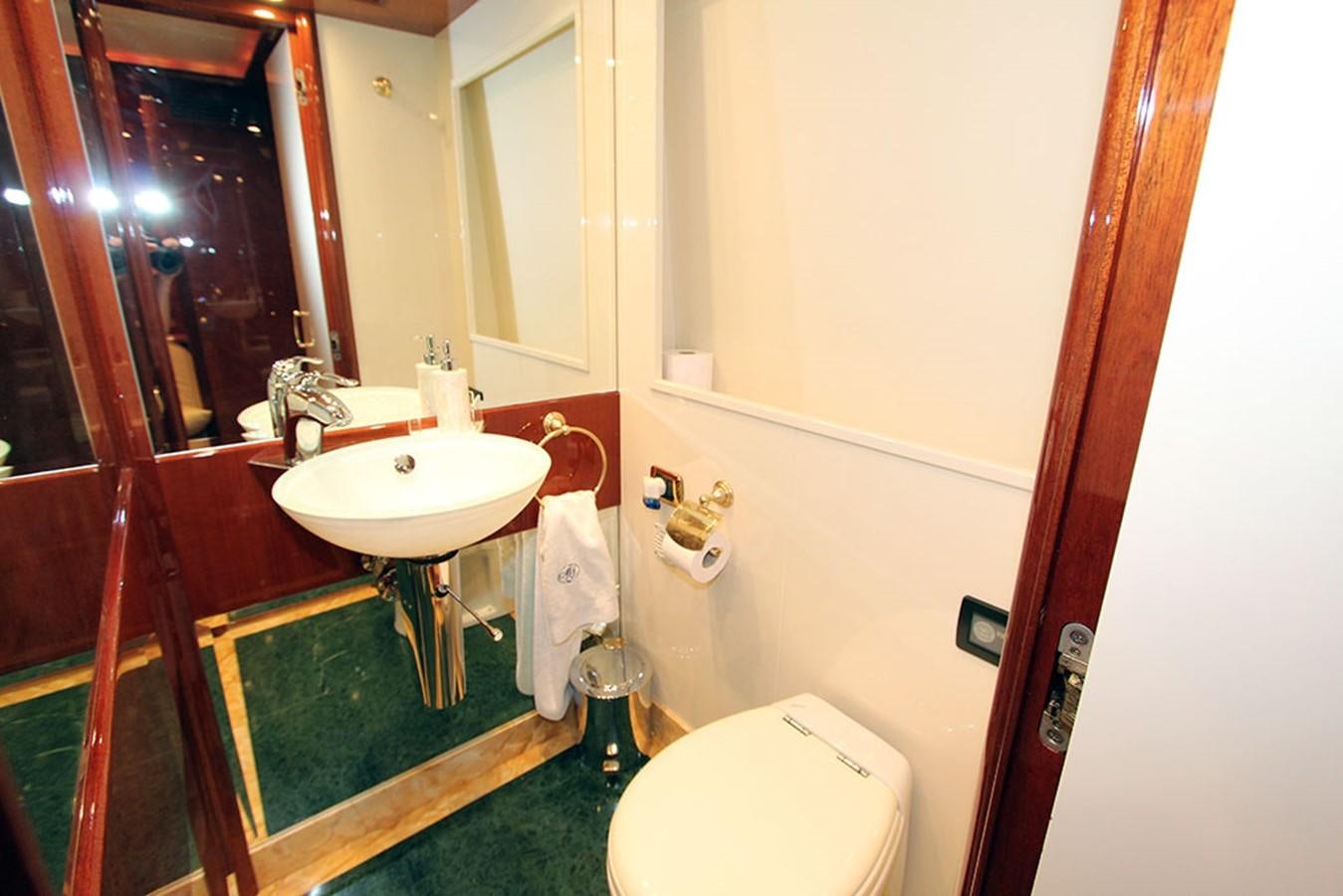 a bathroom with a sink toilet and a mirror aboard MARIA JOSE Yacht for Sale