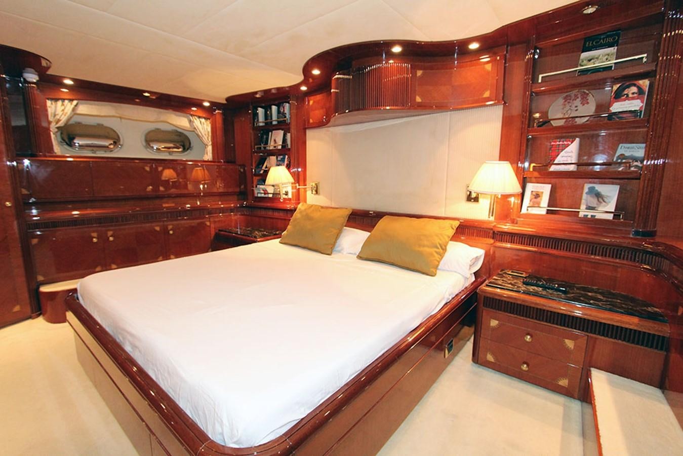 a room with a bed and a shelf with books aboard MARIA JOSE Yacht for Sale