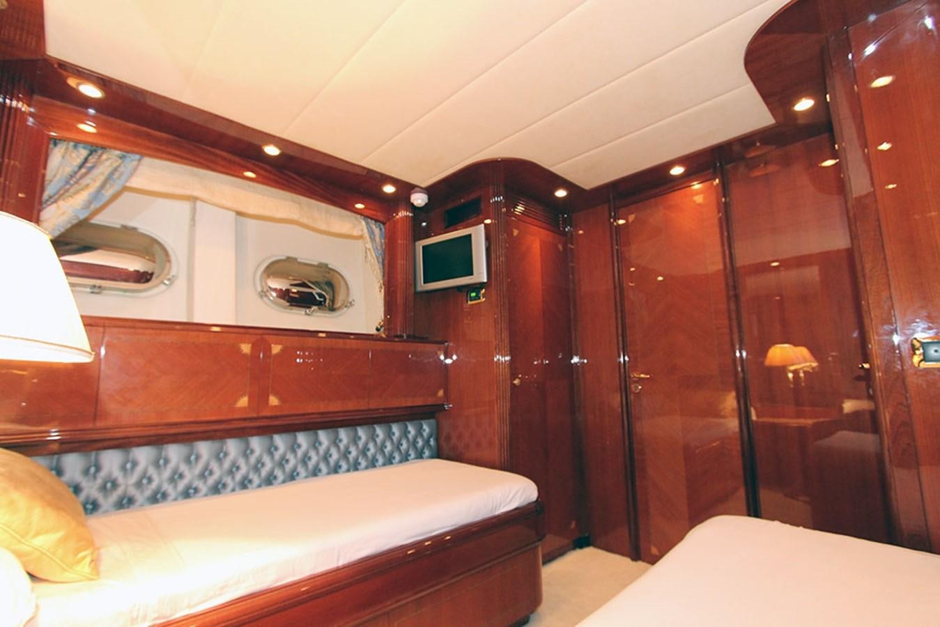 a room with a bed and a mirror aboard MARIA JOSE Yacht for Sale