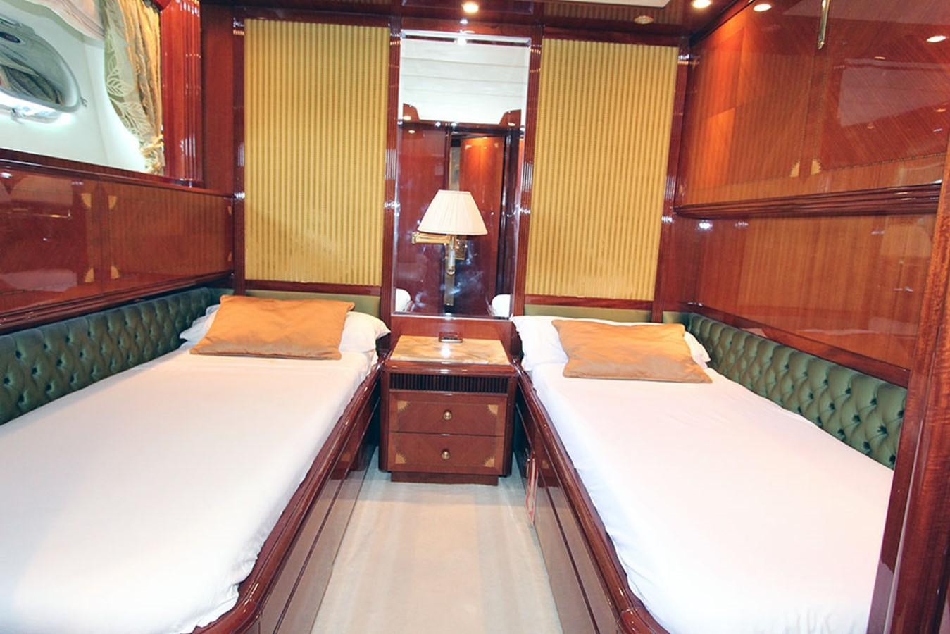 a room with beds and a mirror aboard MARIA JOSE Yacht for Sale