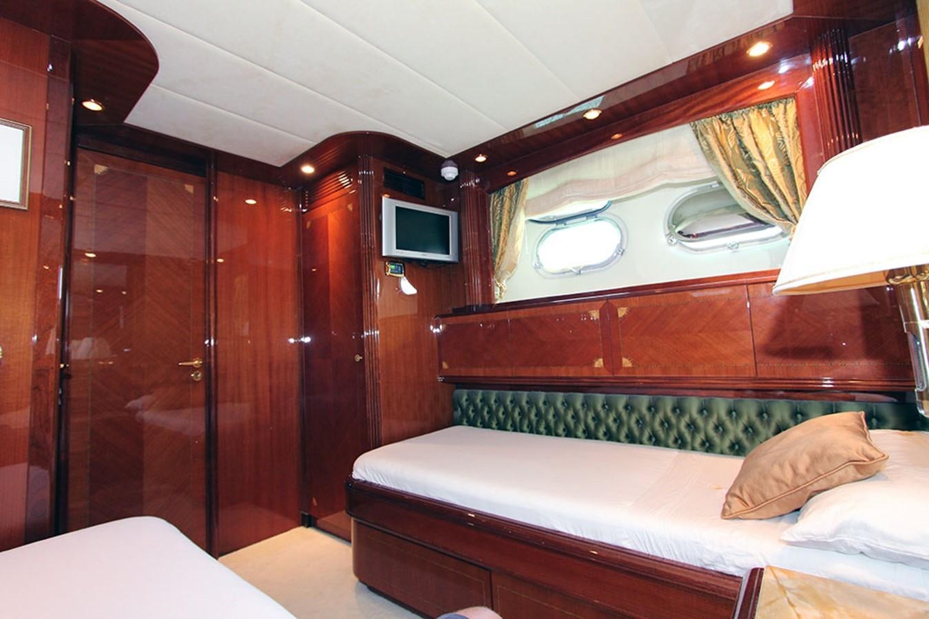 a room with a bed and a television aboard MARIA JOSE Yacht for Sale