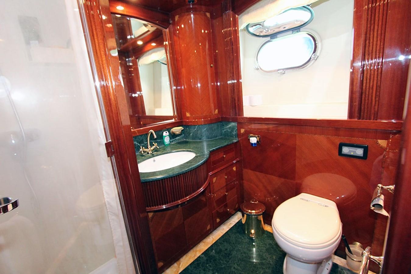 a bathroom with a sink toilet and a mirror aboard MARIA JOSE Yacht for Sale