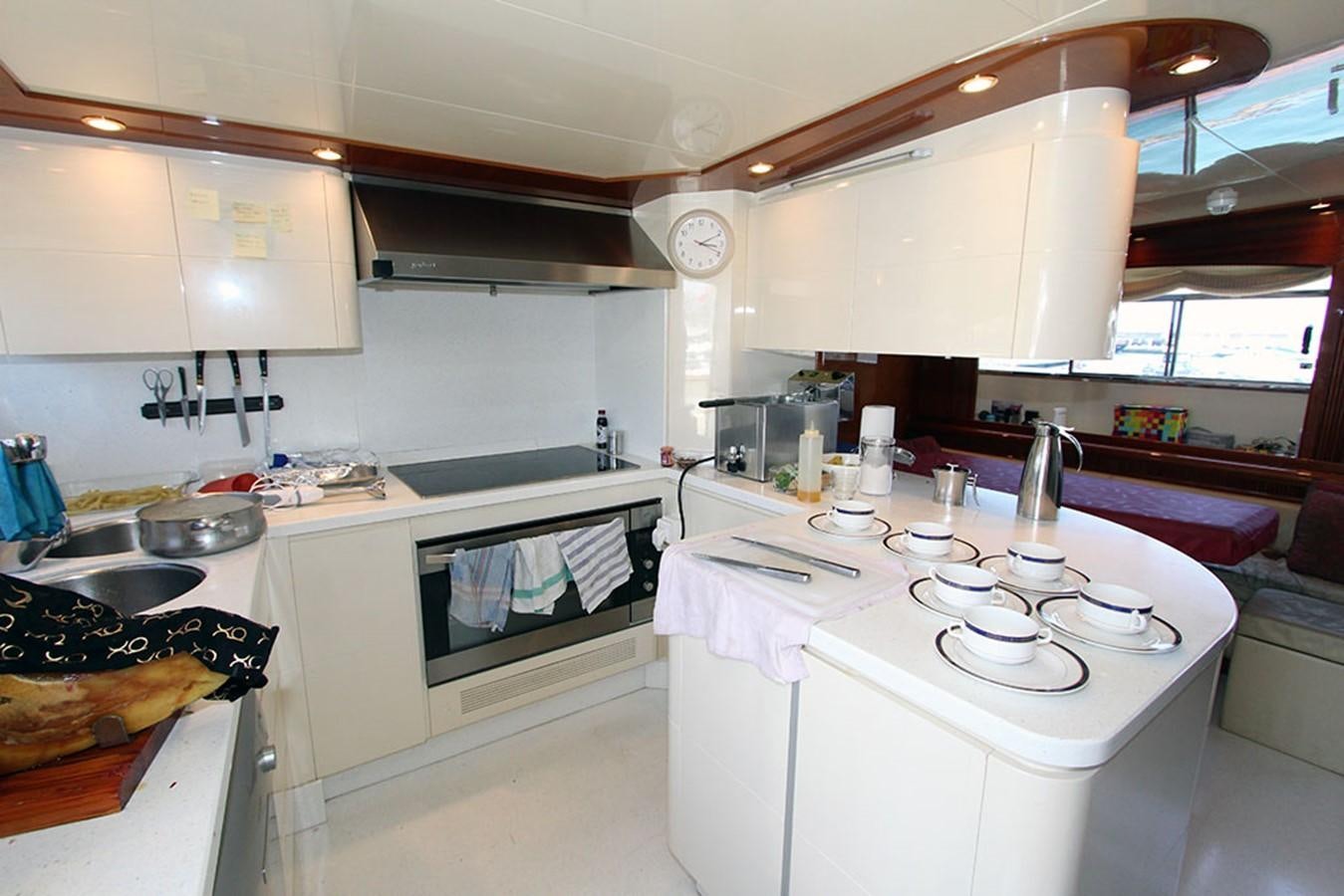 a kitchen with white cabinets aboard MARIA JOSE Yacht for Sale