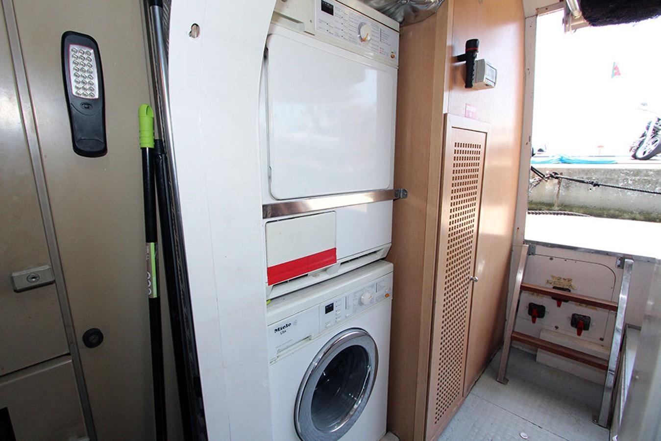 a room with a washing machine and dryer aboard MARIA JOSE Yacht for Sale